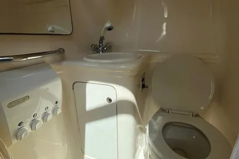 Slide: The Image of 2003 Sea Ray 260 Sundancer boat bathroom with sink and toilet. - 43