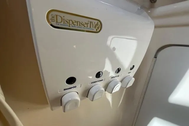 Slide: The Image of Wall-mounted dispenser with shampoo, conditioner, and soap in a 2003 Sea Ray 260 Sundancer. - 44