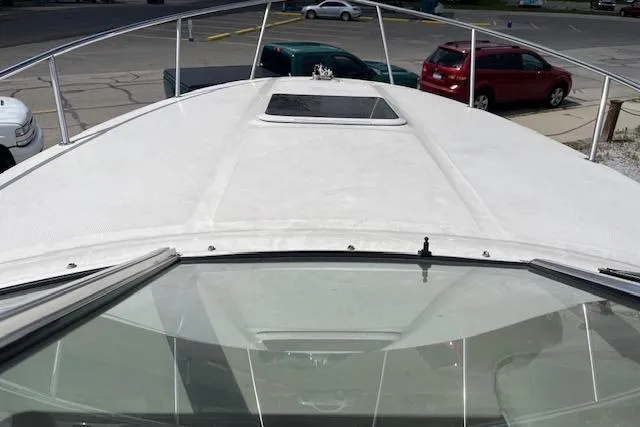 Slide: The Image of 2003 Sea Ray 260 Sundancer boat deck view in a parking area. - 47