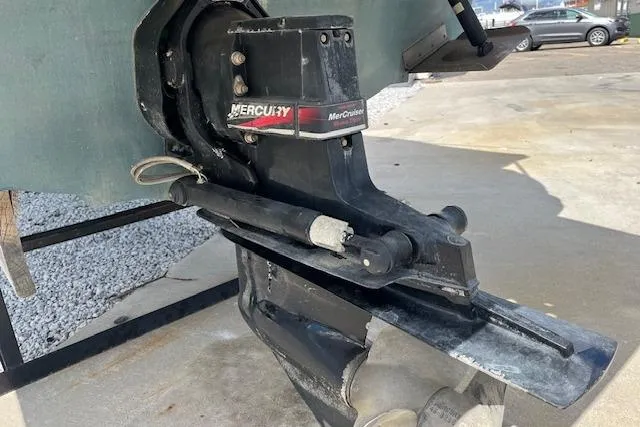 Slide: The Image of 2003 Sea Ray 260 Sundancer with MerCruiser outdrive, parked on concrete surface. - 49