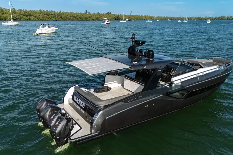 Slide: The Image of 2023 Azimut Verve 47 luxury yacht on a serene waterway with other boats. - 12