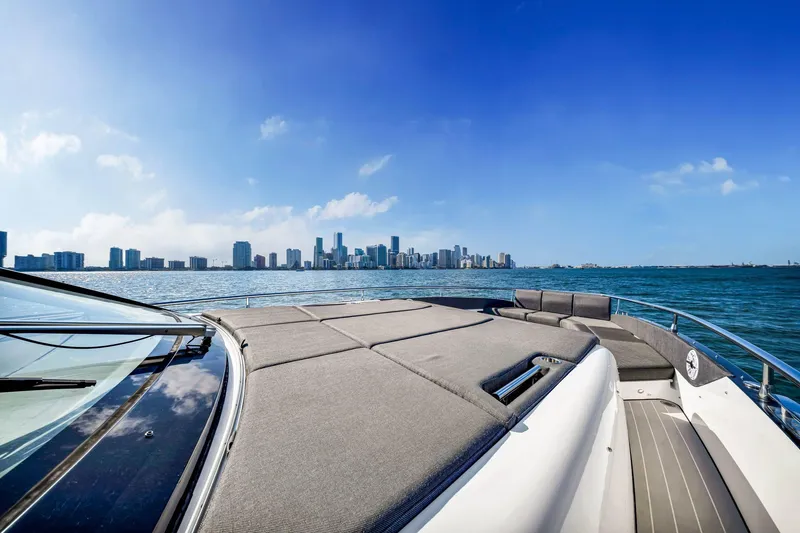 Slide: The Image of 2023 Azimut Verve 47 yacht cruising with city skyline in the background. - 22