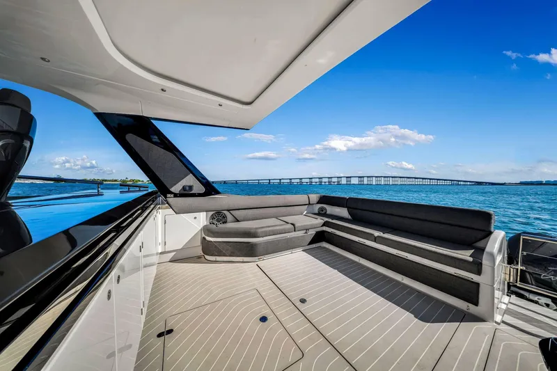 Slide: The Image of 2023 Azimut Verve 47 yacht with spacious deck, overlooking serene blue waters and distant bridge. - 27