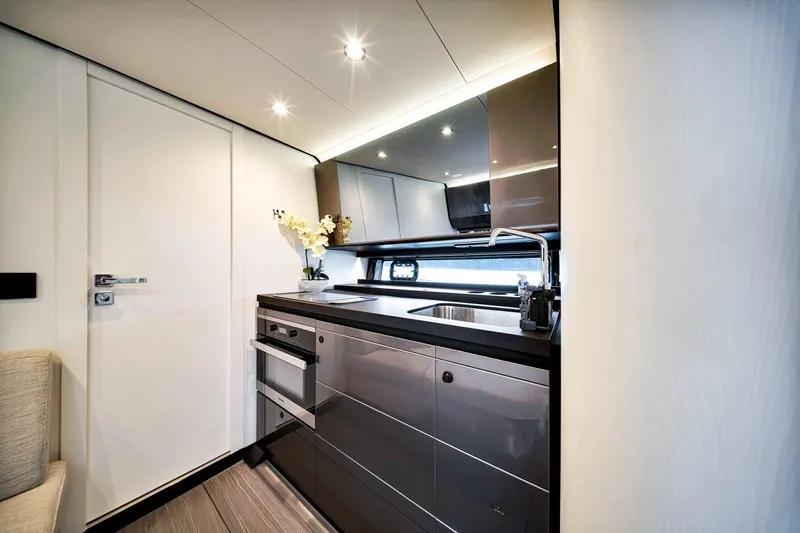 Slide: The Image of Luxurious kitchen interior of 2023 Azimut Verve 47 yacht, featuring modern appliances and sleek design. - 29