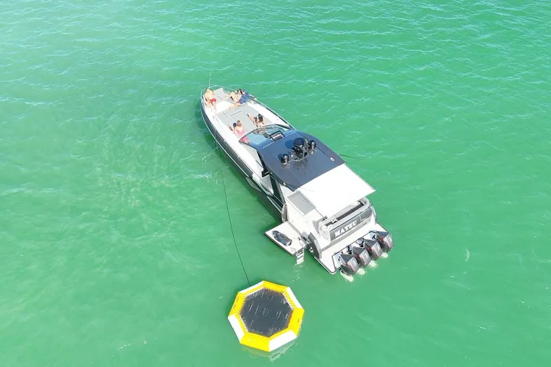 Slide: The Image of 2023 Azimut Verve 47 yacht on turquoise water with people relaxing onboard. - 6