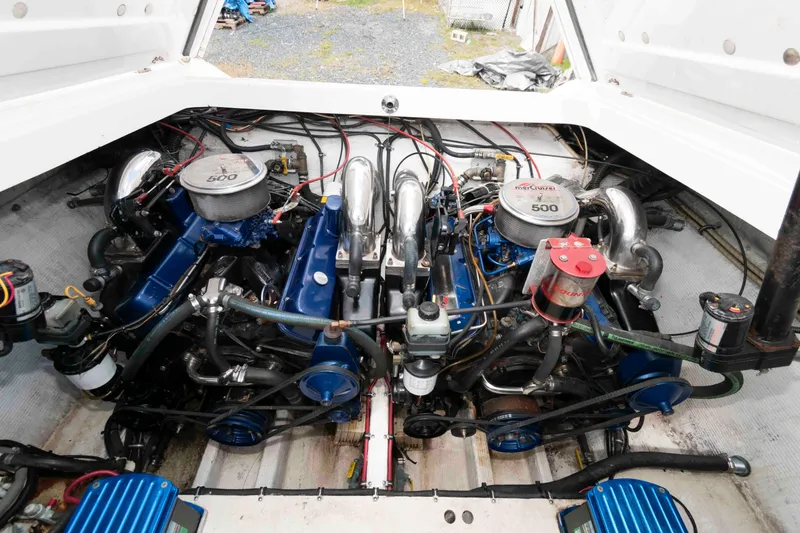Slide: The Image of Engine compartment of a 1999 Fountain 38 Lightning boat, featuring dual high-performance engines. - 12