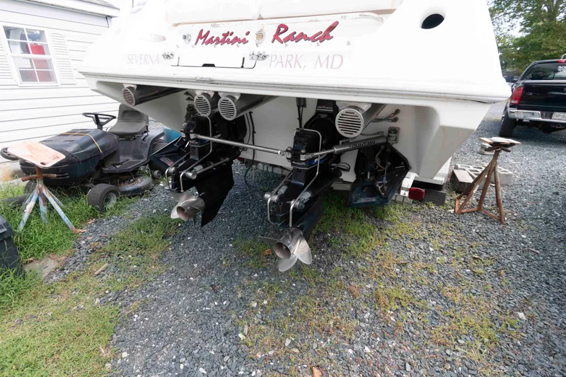 Slide: The Image of 1999 Fountain 38 Lightning boat with dual outboard motors on gravel driveway. - 13