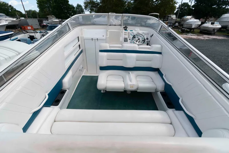 Slide: The Image of 1999 Fountain 38 Lightning boat interior with white seating and teal accents. - 3