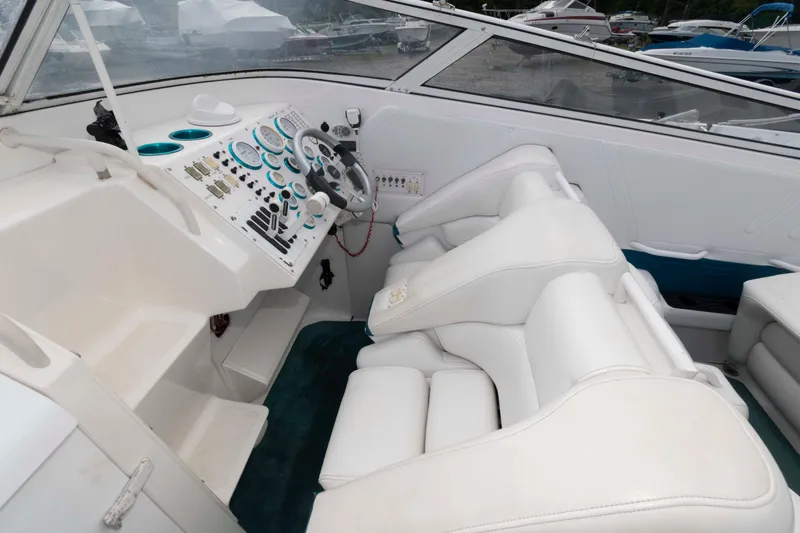 Slide: The Image of 1999 Fountain 38 Lightning boat interior with white seating and control panel. - 4
