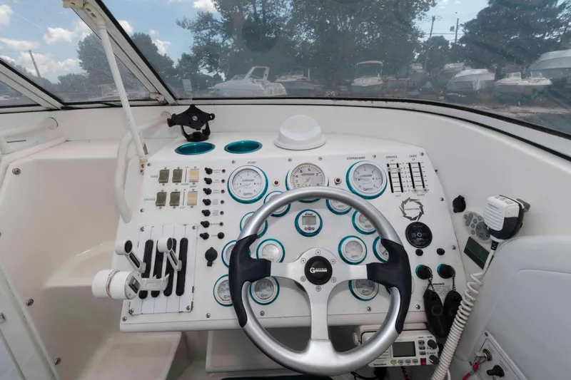 Slide: The Image of Cockpit of 1999 Fountain 38 Lightning boat with steering wheel and control panel. - 6
