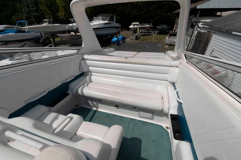 Slide: The Image of 1999 Fountain 38 Lightning boat interior with white seating and teal carpet. - 7