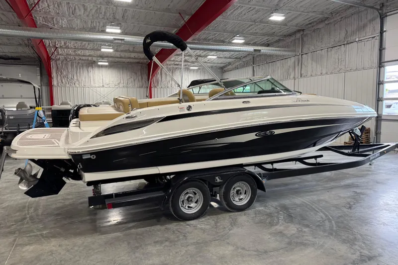 Slide: The Image of 2011 Sea Ray 240 Sundeck boat on trailer in indoor storage facility. - 3