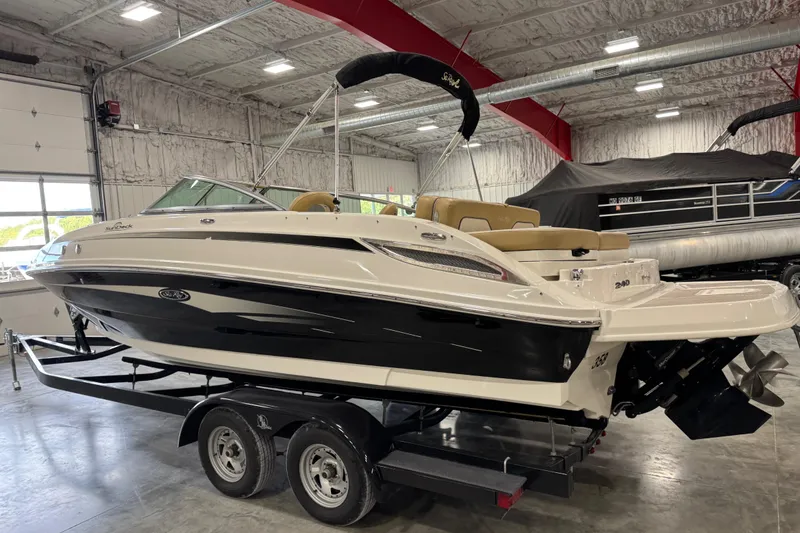 Slide: The Image of 2011 Sea Ray 240 Sundeck boat on trailer in indoor storage facility. - 4