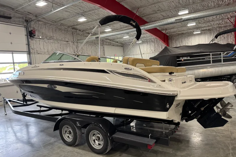Slide: The Image of 2011 Sea Ray 240 Sundeck boat on trailer in indoor storage facility. - 5