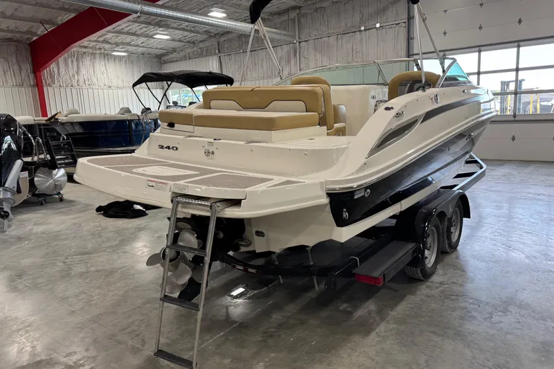 Slide: The Image of 2011 Sea Ray 240 Sundeck boat on trailer in indoor showroom. - 6