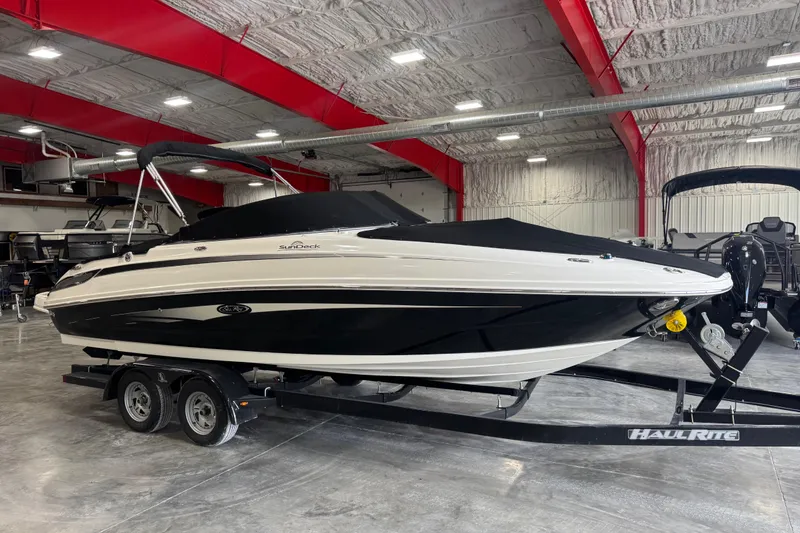 Slide: The Image of 2011 Sea Ray 240 Sundeck boat on trailer in indoor showroom. - 7