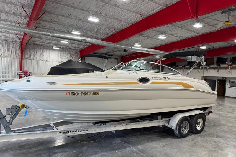Slide: The Image of 2001 Sea Ray 240 Sundeck boat on trailer in indoor storage facility. - 1