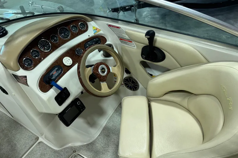 Slide: The Image of 2001 Sea Ray 240 Sundeck helm with beige leather seat and instrument panel. - 11