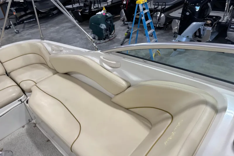 Slide: The Image of 2001 Sea Ray 240 Sundeck interior with beige seating and stainless steel railings. - 14