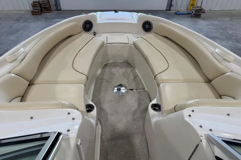 Slide: The Image of 2001 Sea Ray 240 Sundeck interior with beige seating and carpeted floor. - 15