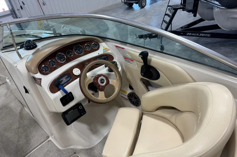 Slide: The Image of Interior view of 2001 Sea Ray 240 Sundeck boat cockpit with steering wheel and gauges. - 16