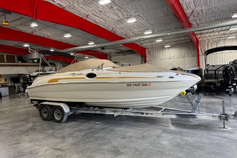 Slide: The Image of 2001 Sea Ray 240 Sundeck boat on trailer in indoor storage facility. - 17