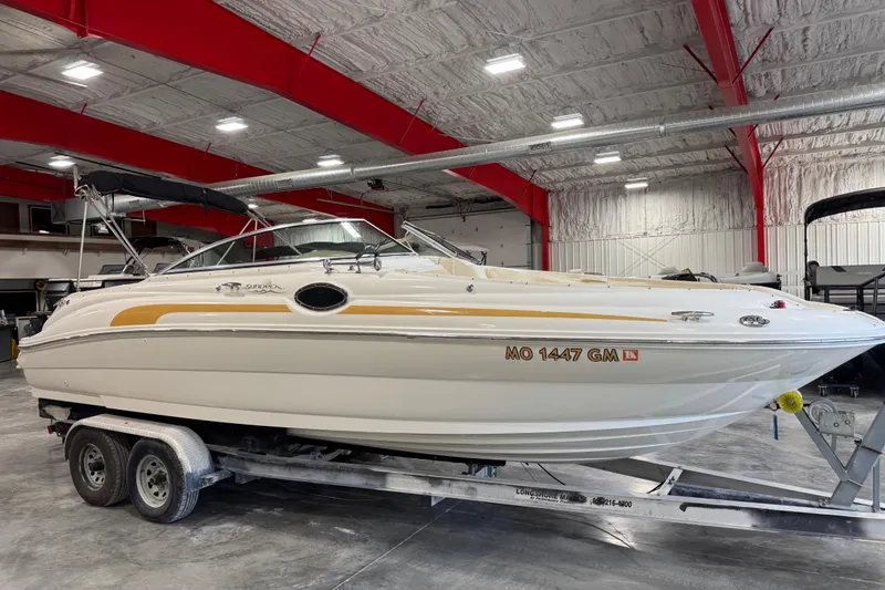 Slide: The Image of 2001 Sea Ray 240 Sundeck boat on trailer in indoor storage facility. - 2