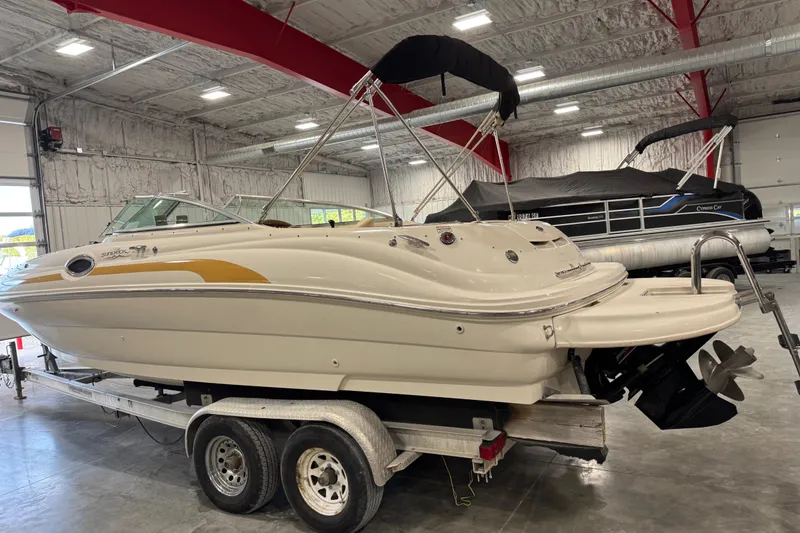 Slide: The Image of 2001 Sea Ray 240 Sundeck boat on trailer in indoor storage facility. - 3