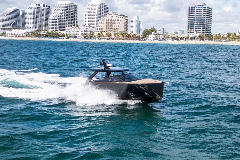 Slide: The Image of Luxury Colnago C38 OPEN yacht cruising near a coastal city skyline, 2025 model. - 26