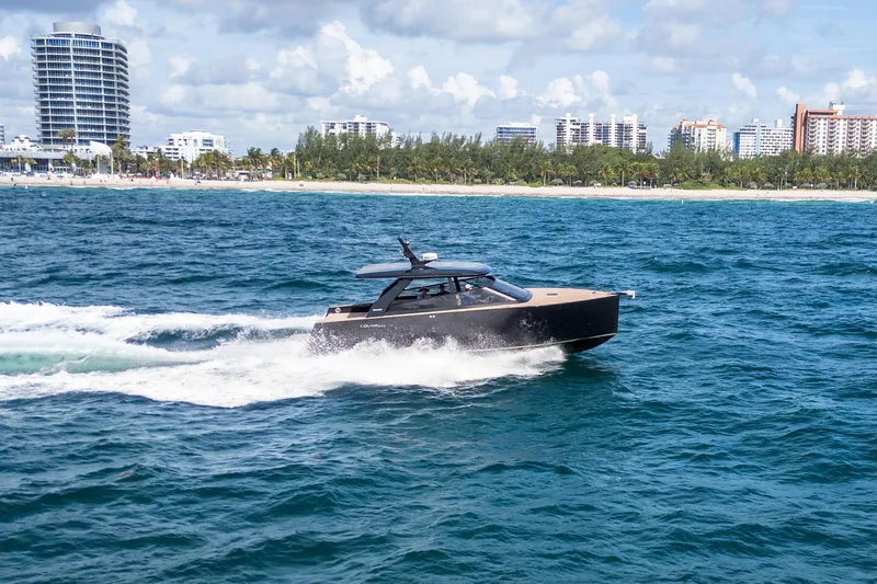 Slide: The Image of Luxury Colnago C38 OPEN yacht cruising near a city shoreline, 2025 model. - 27