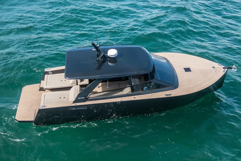 Slide: The Image of 2025 Colnago C38 OPEN luxury boat cruising on clear blue water. - 31