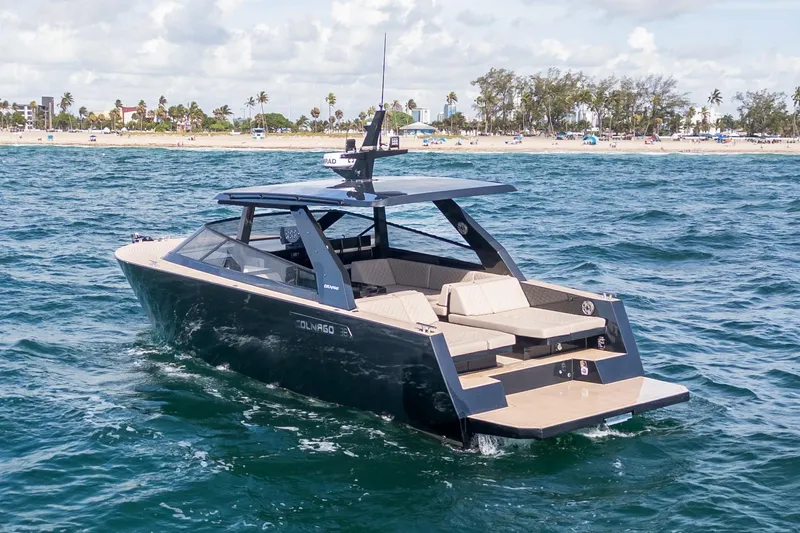 Slide: The Image of 2025 Colnago C38 OPEN yacht cruising near a sandy beach under a partly cloudy sky. - 47