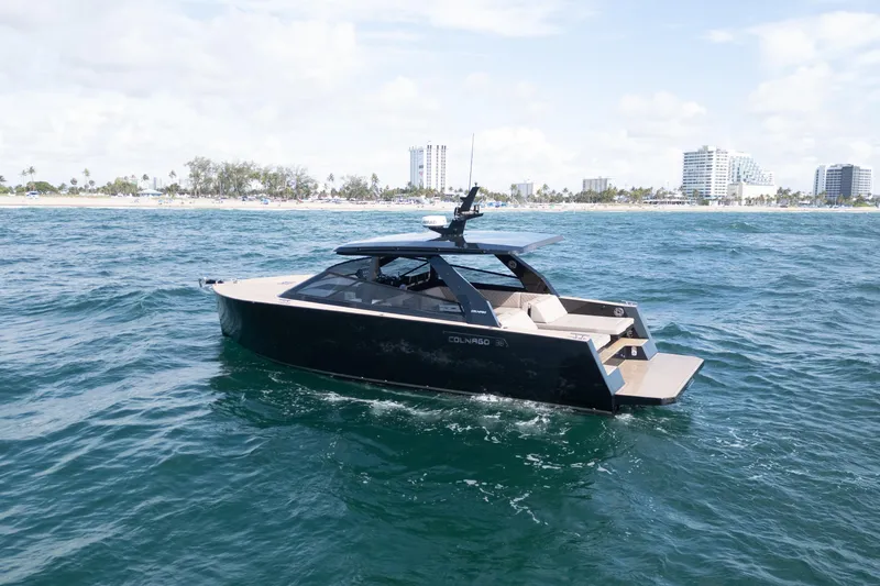 Slide: The Image of 2025 Colnago C38 OPEN yacht cruising near a coastal city skyline. - 49