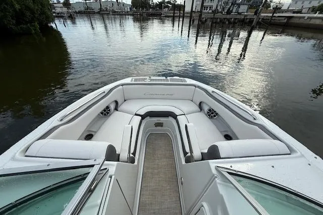 Slide: The Image of 2021 Crownline Eclipse E235 XS boat interior with plush seating on calm water. - 2