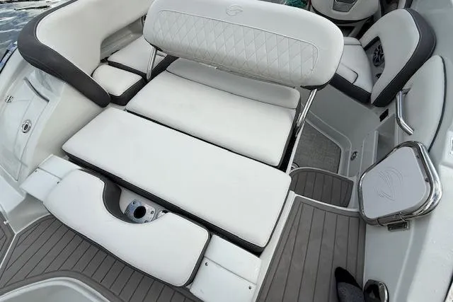 Slide: The Image of 2021 Crownline Eclipse E235 XS boat interior with white cushioned seating and sleek design. - 5