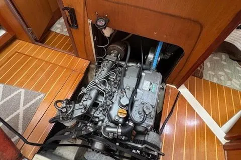 Slide: The Image of Engine compartment of a 1999 Hunter 410 sailboat, showcasing detailed mechanical components. - 10