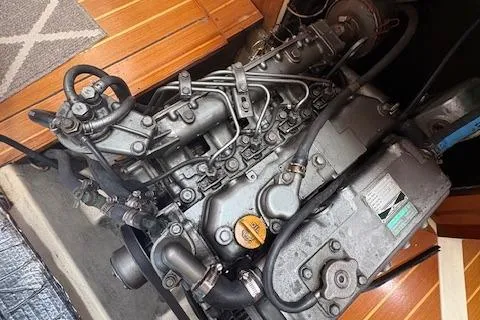 Slide: The Image of Engine of a 1999 Hunter 410 sailboat, showcasing intricate mechanical components. - 11