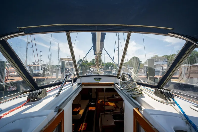 Slide: The Image of Interior view of a 1999 Hunter 410 sailboat docked at a marina. - 14