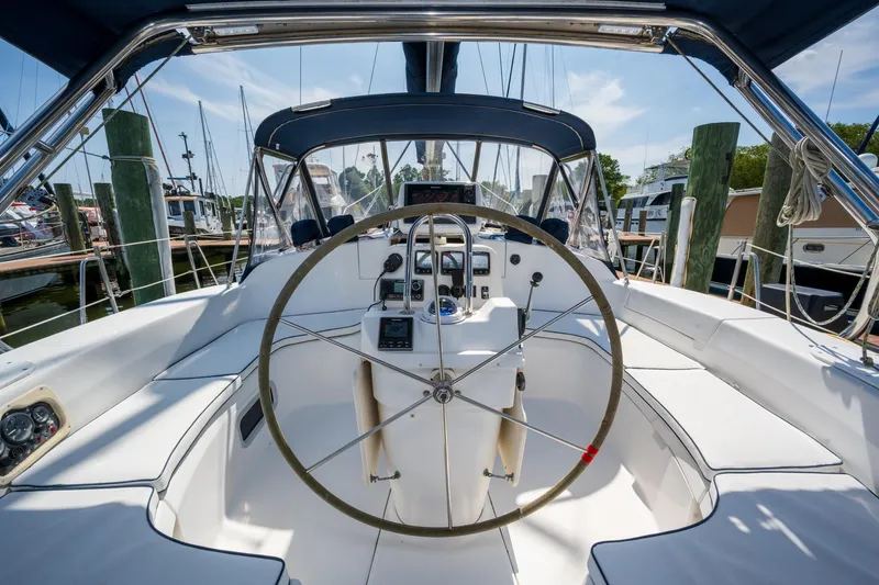 Slide: The Image of Cockpit of 1999 Hunter 410 sailboat with steering wheel and navigation instruments. - 3