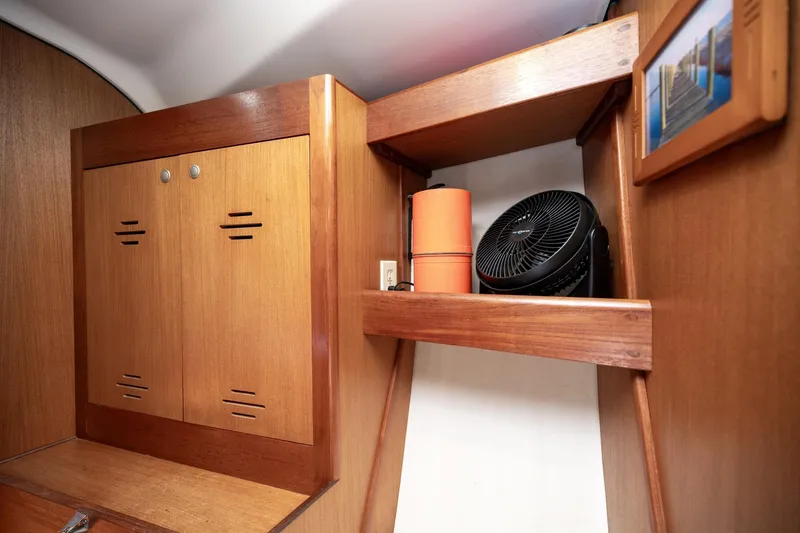 Slide: The Image of Wooden interior of 1999 Hunter 410 yacht with shelves and fan. - 30