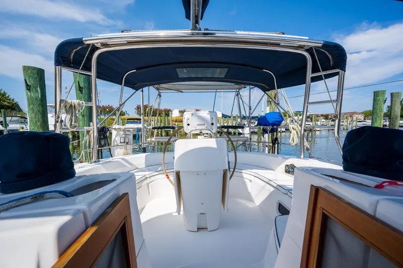 Slide: The Image of Cockpit view of 1999 Hunter 410 sailboat docked at marina under blue sky. - 32