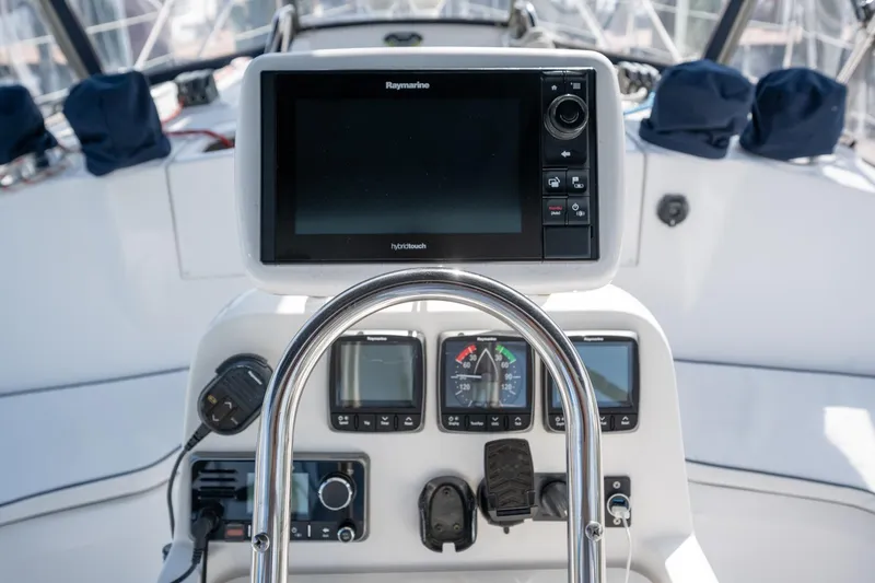 Slide: The Image of Cockpit of 1999 Hunter 410 sailboat with navigation instruments and steering wheel. - 33