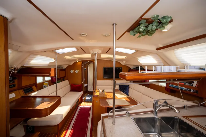 Slide: The Image of Interior of 1999 Hunter 410 sailboat with cozy seating and modern amenities. - 4