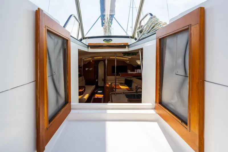Slide: The Image of Interior view of 1999 Hunter 410 sailboat cabin with open wooden doors. - 6