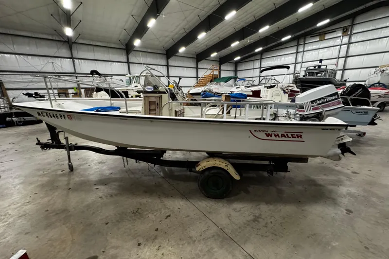 Slide: The Image of 1991 Boston Whaler 17 Montauk boat in indoor storage, side view. - 16