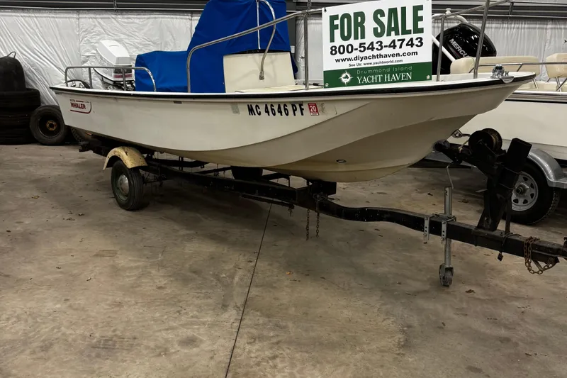 Slide: The Image of 1991 Boston Whaler 17 Montauk boat for sale on trailer in indoor storage. - 19