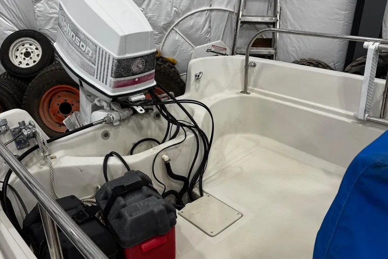 Slide: The Image of 1991 Boston Whaler 17 Montauk boat interior with Johnson outboard motor. - 6