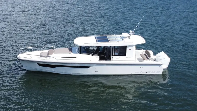 Slide: The Image of Nimbus Commuter 11 #086, 2025 model, cruising on calm blue waters. - 3