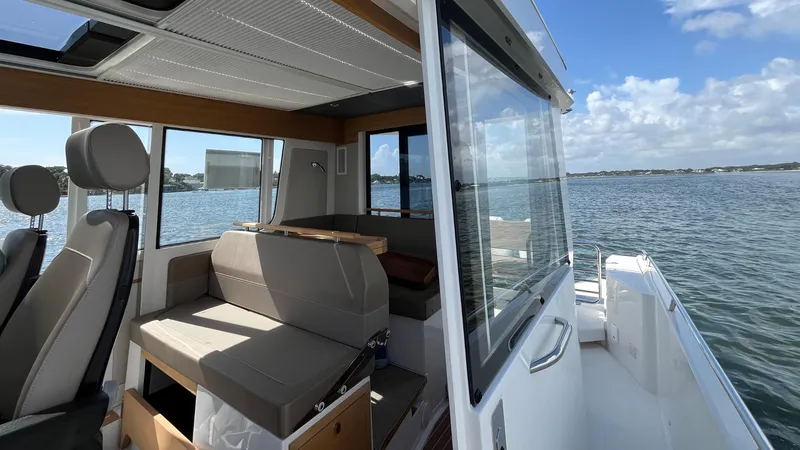 Slide: The Image of Modern Nimbus Commuter 11 boat interior with seating, overlooking serene waters, 2025 model. - 39