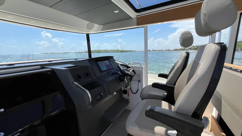 Slide: The Image of Interior of 2025 Nimbus Commuter 11 boat with modern cockpit and ocean view. - 30